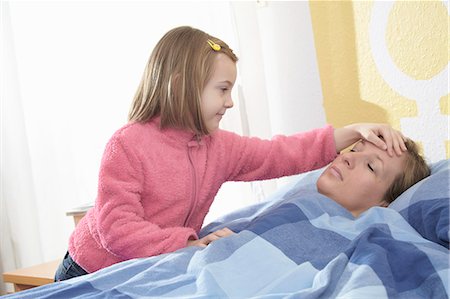 sick child - Girl feeling sick mothers forehead Stock Photo - Premium Royalty-Free, Code: 649-06717638