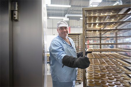 rack - Worker baking biscuits in factory Stock Photo - Premium Royalty-Free, Code: 649-06717684