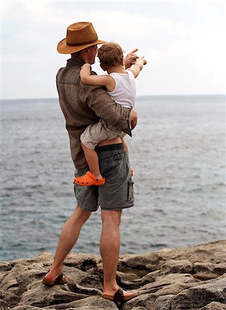 family standing back rear view - Father holding son outdoors Stock Photo - Premium Royalty-Free, Code: 649-06717806