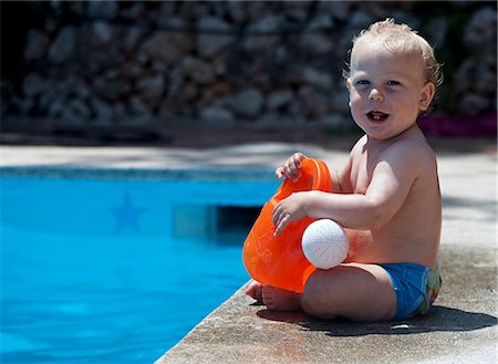 Baby boy sitting by swimming pool Stock Photo - Premium Royalty-Free, Code: 649-06717801