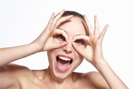 funny women - Smiling woman making face Stock Photo - Premium Royalty-Free, Code: 649-06717840