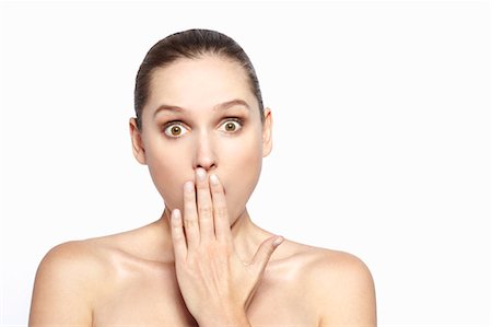 surprised people eye contact - Surprised woman covering her mouth Stock Photo - Premium Royalty-Free, Code: 649-06717843