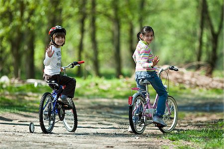 family on bicycle in park - Girls riding bicycles in park Stock Photo - Premium Royalty-Free, Code: 649-06717905