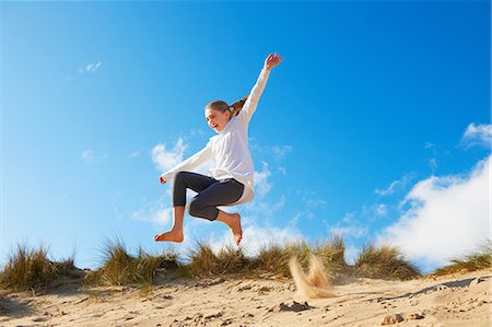 people leaping - Girl jumping on beach Stock Photo - Premium Royalty-Free, Code: 649-06812034