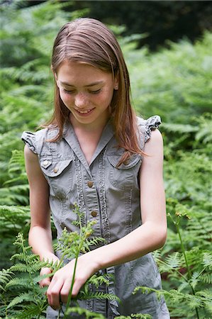 Teenage girl touching bracken in forest Stock Photo - Premium Royalty-Free, Code: 649-06812067