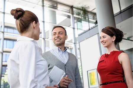 Three business people standing and talking Stock Photo - Premium Royalty-Free, Code: 649-06812111