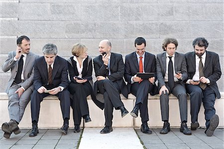 Business people sitting in a row and working outdoors Stock Photo - Premium Royalty-Free, Code: 649-06812266