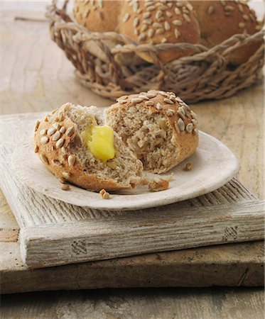 simsearch:649-06812315,k - Sunflower and honey wheat sheaf bread roll with butter Stock Photo - Premium Royalty-Free, Code: 649-06812336