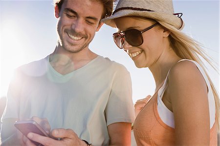 social networking - Young couple looking at smartphone Stock Photo - Premium Royalty-Free, Code: 649-06812356