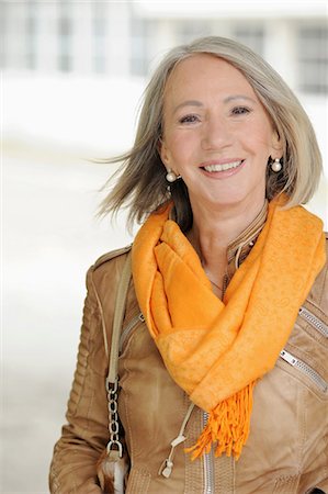 Portrait of senior woman in orange scarf Stock Photo - Premium Royalty-Free, Code: 649-06812374