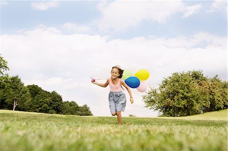 people running grass park - Girl holding balloons running on grass Stock Photo - Premium Royalty-Free, Code: 649-06812429