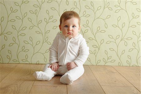 pouting kid - Baby girl sitting on floor Stock Photo - Premium Royalty-Free, Code: 649-06812524