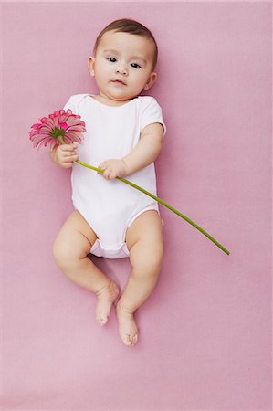 Baby girl with gerbera flowers Stock Photo - Premium Royalty-Free, Code: 649-06812539