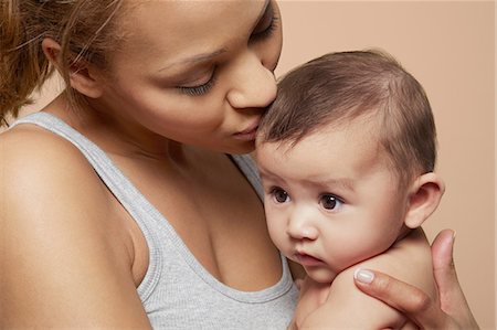 people head - Mother kissing her baby girl Stock Photo - Premium Royalty-Free, Code: 649-06812546