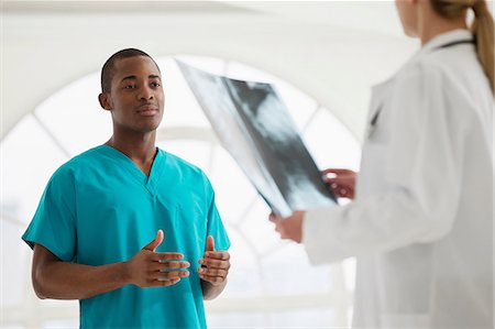 Two doctors looking at xray Stock Photo - Premium Royalty-Free, Code: 649-06812577