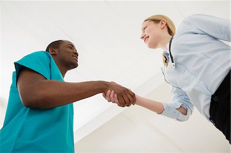 Two doctors shaking hands, low angle Stock Photo - Premium Royalty-Free, Code: 649-06812587