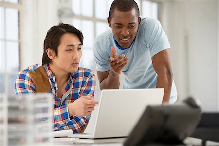 Two male colleagues using laptop Stock Photo - Premium Royalty-Free, Code: 649-06812604