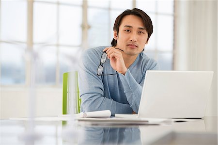 Businessman sitting at desk working Stock Photo - Premium Royalty-Free, Code: 649-06812612