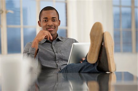 single shoes - Male office worker sitting at desk with feet up Stock Photo - Premium Royalty-Free, Code: 649-06812625