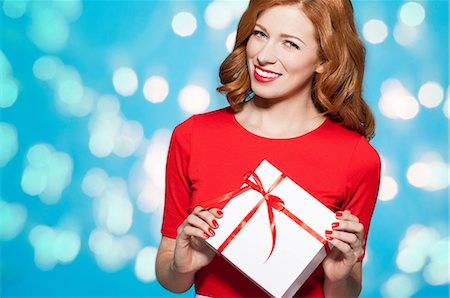 delighted gift - Woman holding white gift box with red bow Stock Photo - Premium Royalty-Free, Code: 649-06812637