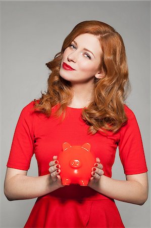 Woman holding red piggy bank Stock Photo - Premium Royalty-Free, Code: 649-06812656