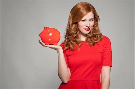 saving piggy bank - Woman holding red piggy bank Stock Photo - Premium Royalty-Free, Code: 649-06812658