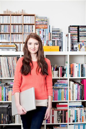 Portrait of female student in front of bookcase Stock Photo - Premium Royalty-Free, Code: 649-06812718