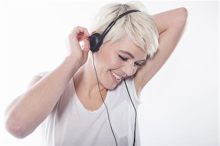 Woman wearing earphones Stock Photo - Premium Royalty-Free, Code: 649-06812772
