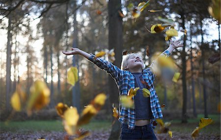 exploring children - Boy throwing leaves in air Stock Photo - Premium Royalty-Free, Code: 649-06812986