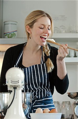 female cleaning home - Woman tasting dough mix Stock Photo - Premium Royalty-Free, Code: 649-06813057