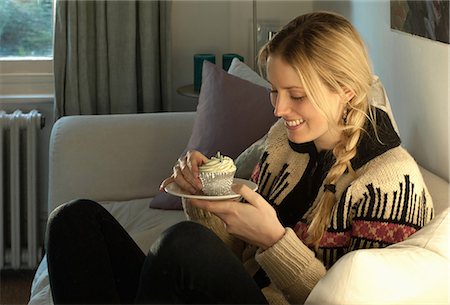 finished - Woman about to eat cupcake Stock Photo - Premium Royalty-Free, Code: 649-06813064