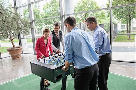 red shirt - Businesspeople playing table football in lobby Stock Photo - Premium Royalty-Free, Code: 649-06829456