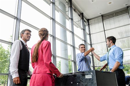 Businessmen winning at table football in lobby Photographie de stock - Premium Libres de Droits, Code: 649-06829457