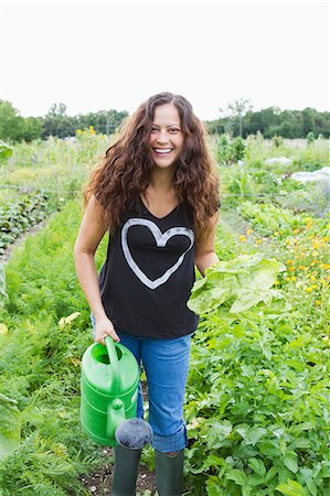 portrait natural woman - Young woman holding watering can in allotment Stock Photo - Premium Royalty-Free, Code: 649-06829480