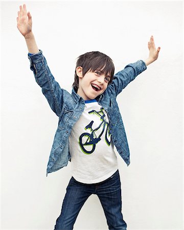 funky - Portrait of boy with arms out against white background Photographie de stock - Premium Libres de Droits, Code: 649-06829572
