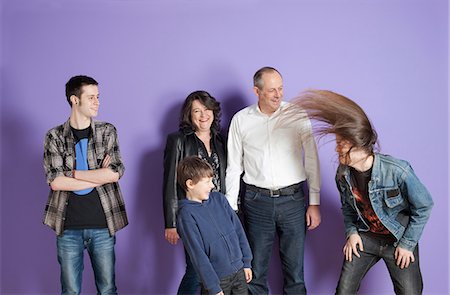 dad teenage son - Family watching son headbang in front of purple background Stock Photo - Premium Royalty-Free, Code: 649-06829582