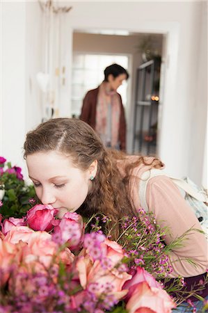 rosa - Teenage girl smelling bouquet in florists Stock Photo - Premium Royalty-Free, Code: 649-06829652