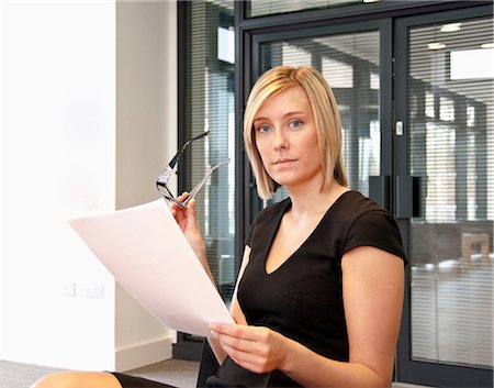 simsearch:649-06829703,k - Female office worker holding glasses and document Stock Photo - Premium Royalty-Free, Code: 649-06829677