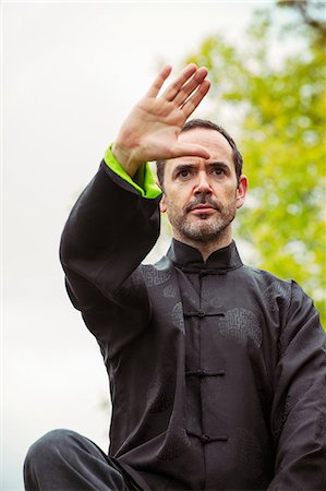 Mature man performing Tai Chi in countryside, front view Stock Photo - Premium Royalty-Free, Code: 649-06829673