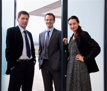 simsearch:649-06829703,k - Portrait of three business colleagues in doorway Stock Photo - Premium Royalty-Free, Code: 649-06829697