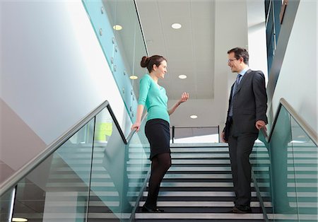 simsearch:649-06829703,k - Colleagues standing on staircase in office building Stock Photo - Premium Royalty-Free, Code: 649-06829712