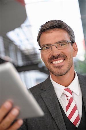 simsearch:649-06829823,k - Close up portrait of businessman holding digital tablet Stock Photo - Premium Royalty-Free, Code: 649-06829824