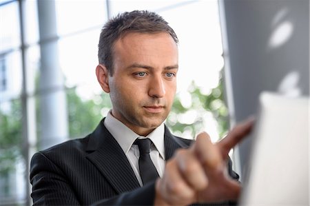 portrait business person close thinking not looking at camera - Businessman interacting with digital tablet screen Stock Photo - Premium Royalty-Free, Code: 649-06829820