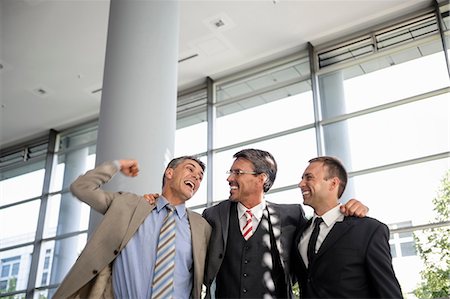 relation with business clients in office - Three businessmen smiling and celebrating Stock Photo - Premium Royalty-Free, Code: 649-06829834