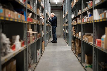 Male warehouse worker searching for item Stock Photo - Premium Royalty-Free, Code: 649-06829908