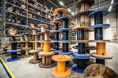 simsearch:6122-08212865,k - Empty cable drums stacked in warehouse Stock Photo - Premium Royalty-Free, Code: 649-06829926