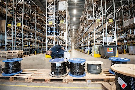 simsearch:649-07239387,k - Male warehouse worker checking pallet order Stock Photo - Premium Royalty-Free, Code: 649-06829923