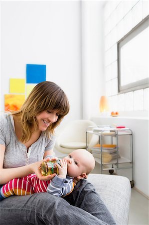 feeding adult baby - Mother feeding baby son with bottle Stock Photo - Premium Royalty-Free, Code: 649-06829990