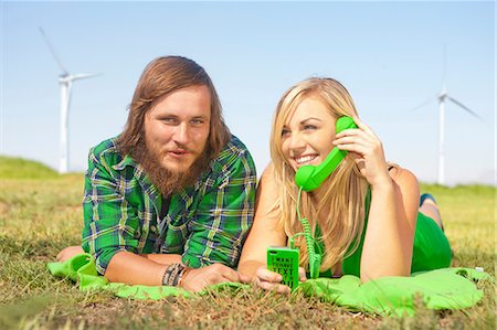 Young couple lying in field, woman on green cell phone Stock Photo - Premium Royalty-Free, Code: 649-06830096