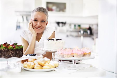 fulfillment - Portrait of woman with selection of hand made cakes Stock Photo - Premium Royalty-Free, Code: 649-06830180